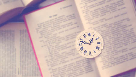 Dial with Roman numerals on books, top view, vintageの写真素材