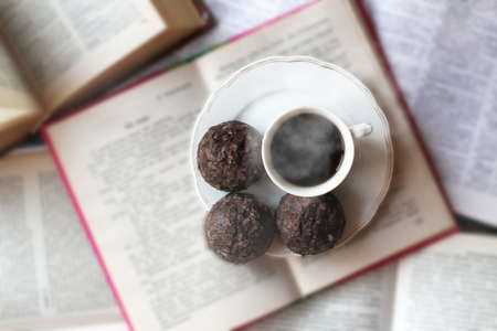 A Cup of coffee at open books, top view, retro imageの写真素材