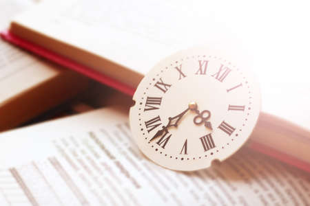 Dial with Roman numerals on books so closeの写真素材