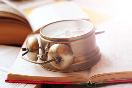 golden vintage clock on antique booksの写真素材