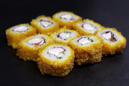 Sushi rolls made of rice, smoked eel, cream cheese and flying fish roe - tobiko caviarの写真素材