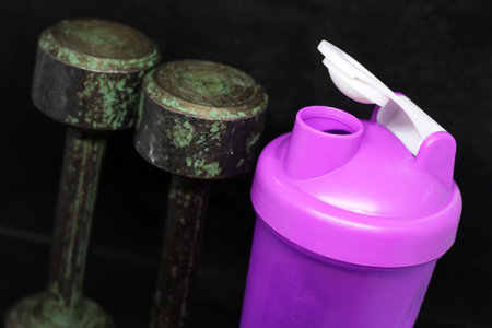 Bodybuilding components: protein shake with a dumbbellの写真素材