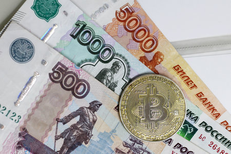 Golden Bitcoins (digital virtual money) and rubles cash. Top view.の写真素材