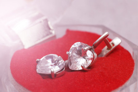 box with silver earrings so close, red color backgroundの写真素材