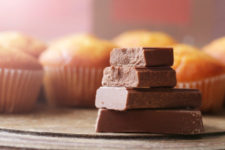 Chocolate pieces on wooden table so close