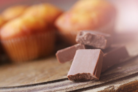 Chocolate pieces on wooden table so close