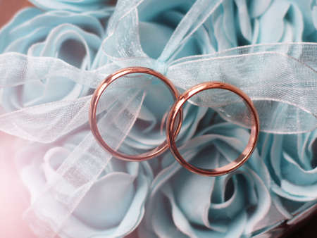 Soap in the shape of a blue flowers and wedding rings so closeの写真素材