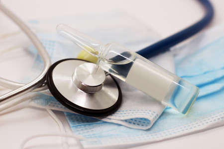 Stethoscope, glass ampoules and medical masks so closeの写真素材