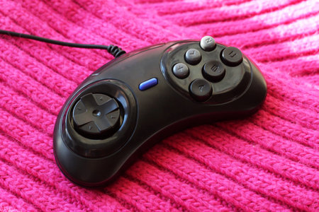 Game joystick on a pink knitted thing