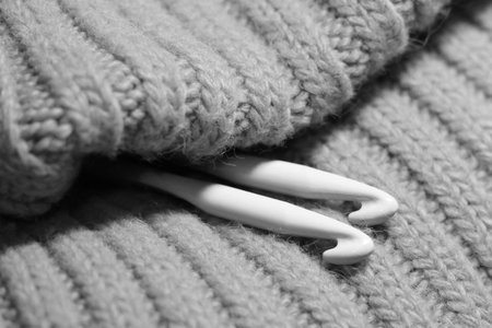 Two crochet hooks on the scarf, black ans white