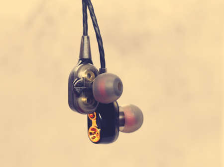 A small boy with large headphones listens to music, indoorの写真素材