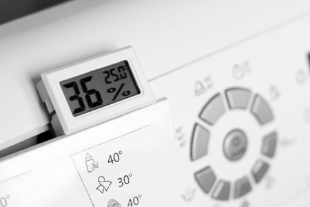Close-up of a washing machine with a digital thermostat