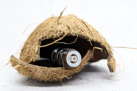 Aroma oil in dark glass and coconut, natural spa setの写真素材