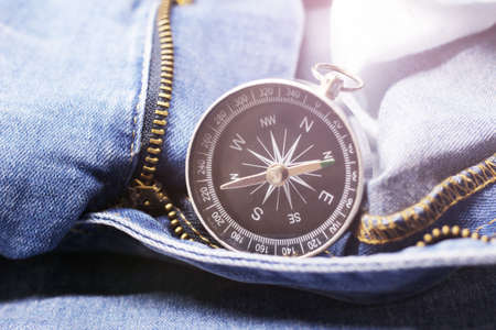 Vintage compass on jeans, travel deviceの写真素材