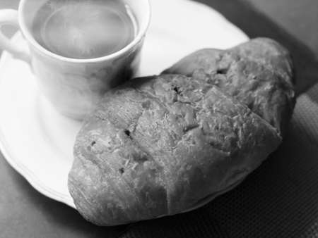 Cappuccino and croissant with coffee beanの写真素材