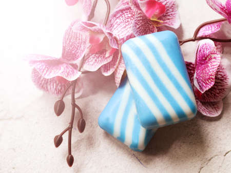 Blue and white soap with orchids on a white background.の写真素材