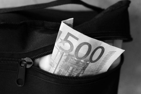 100 euro banknote in a black bag. Black and white photo