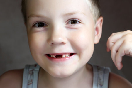 The boy is smiling, a toothless childの写真素材
