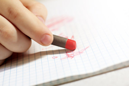 Children's hand with a pencil, school educationの写真素材