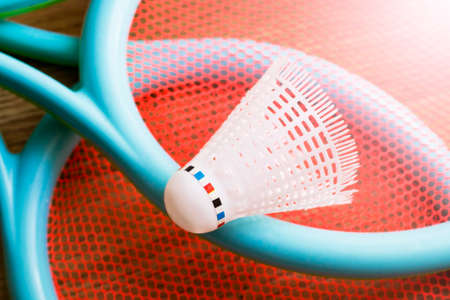 White shuttlecock and badminton racketsの写真素材