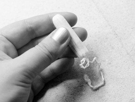Women's sanitary swab in a woman's hand