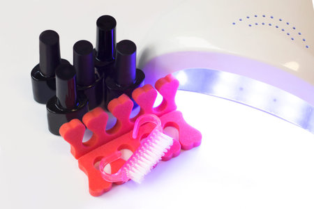 A set of gel nail polish, a lamp and a manicure set
