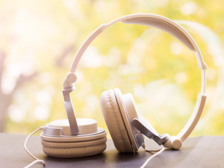 White large headphones on the window, autumn backgroundの写真素材