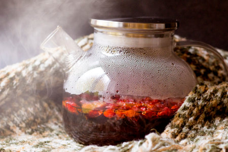 Hot rosehip drink in a glass teapot so closeの写真素材