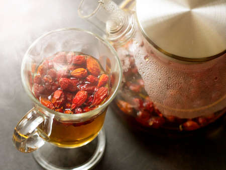 Hot rosehip drink in a glass teapotの写真素材
