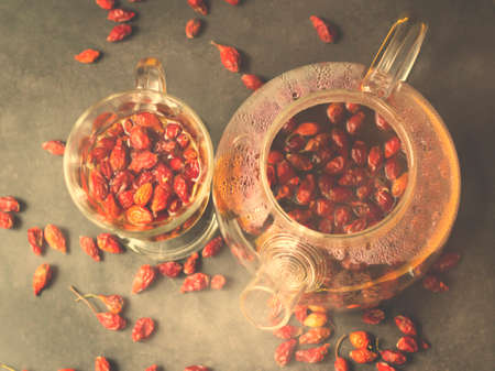 Hot rosehip drink in a glass teapotの写真素材