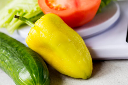 Healthy vegetables on kitchen scales, fresh pepper