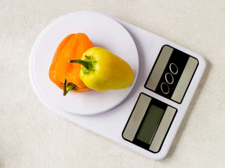 Pepper on the kitchen scale. Diet and weight loss concept.の写真素材