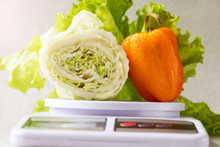 vegetables on the scales, diet and weight loss concept.の写真素材