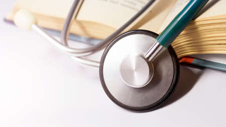 Stethoscope and books on a white background. Medical concept.の写真素材