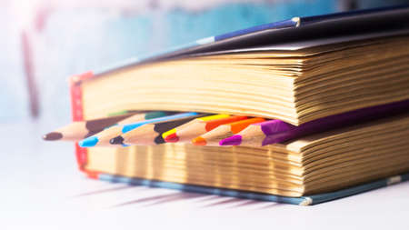Close up of colorful pencils on a book. Education concept.の写真素材