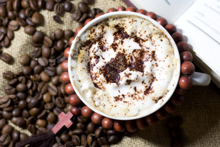 Cup of cappuccino with coffee beans on burlap backgroundの写真素材