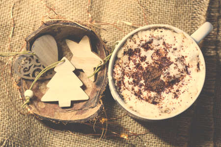 Cappuccino cup and wooden Christmas figurinesの写真素材