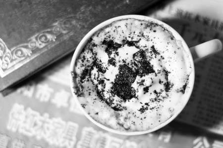 Coffee cup and book on the table in black and whiteの写真素材