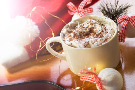 Cup of hot chocolate with whipped cream and christmas decoration.の写真素材