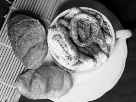Coffee and croissants on the table. Black and white photo.の写真素材