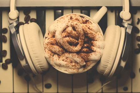 Cup of cappuccino with marshmallows and headphones