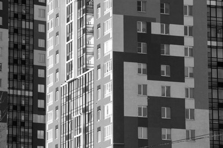 Modern apartment buildings. Facade of a modern apartment building. Black and white photo.