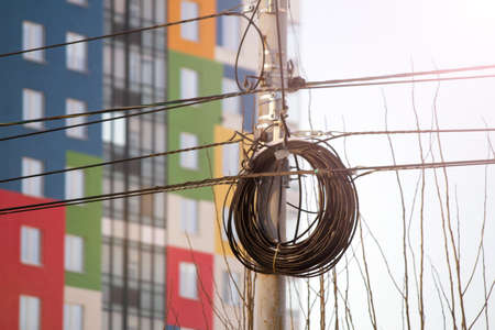 Electricity post with wire and buildings on background. High quality photoの写真素材