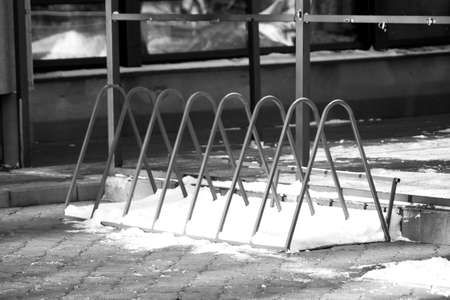 A black and white shot of a rack on the sidewalkの写真素材