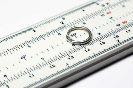 Silver earrings on a measuring device in a pawnshopの写真素材