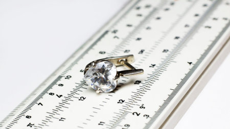 Silver earrings on a measuring device in a pawnshop