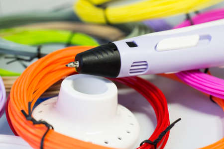 Purple 3d pen and rolls of colored plastic so closeの写真素材