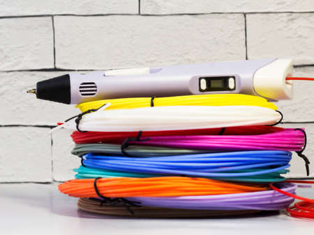 Purple 3d pen and rolls of colored plastic, creative tool, hobbyの写真素材