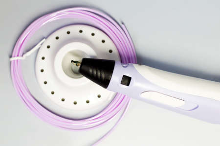 Purple 3d pen and rolls of colored plastic, creative tool, hobbyの写真素材