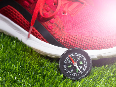 Traveler's shoes and compass so close